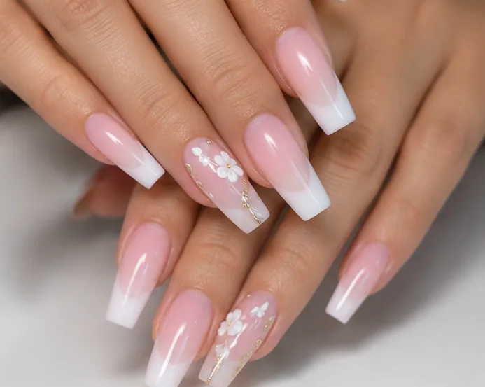 Acrylic French tip nails with floral nail art service photo at Lumi Nails and Beauty Pacific Paradise